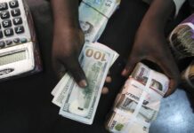 Naira reverses slump, gains N61 to trade at N1,459/$1 at official window